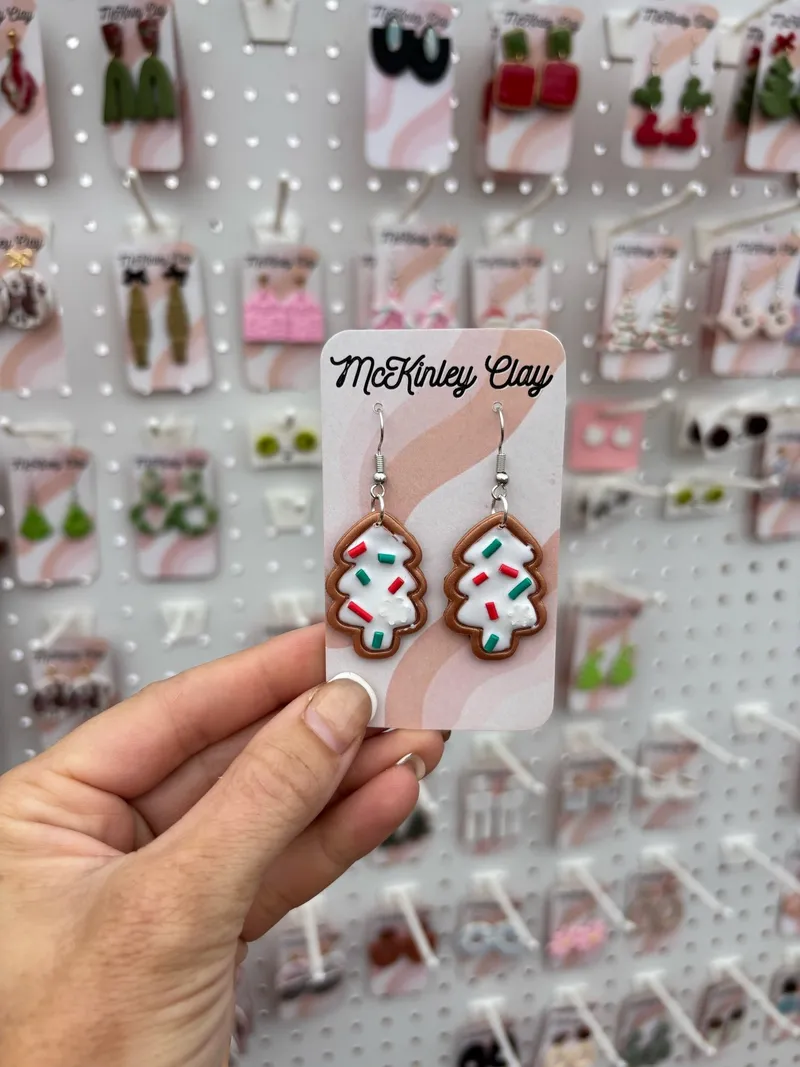 Cookie Tree earrings held up at the McKinley Clay market booth